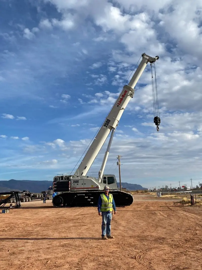 A man standing in front of a crane.