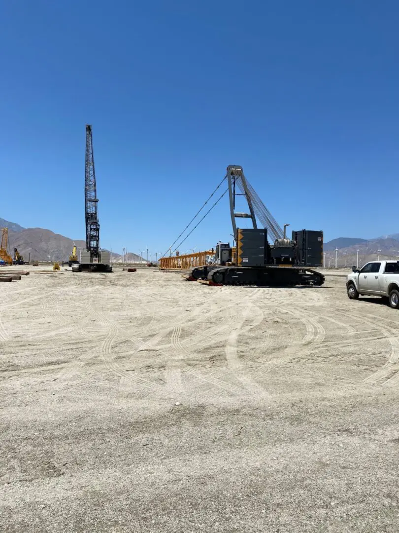 A truck and crane in the desert.