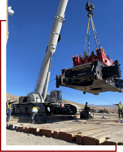 A crane lifting a large piece of machinery.