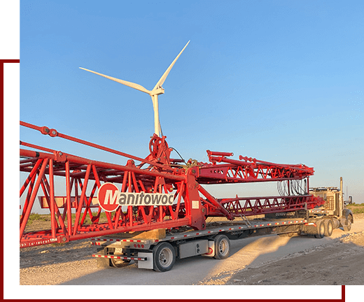 A crane is parked on the side of a road.