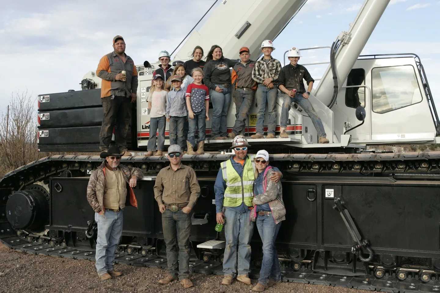 A group of people standing on top of a train.